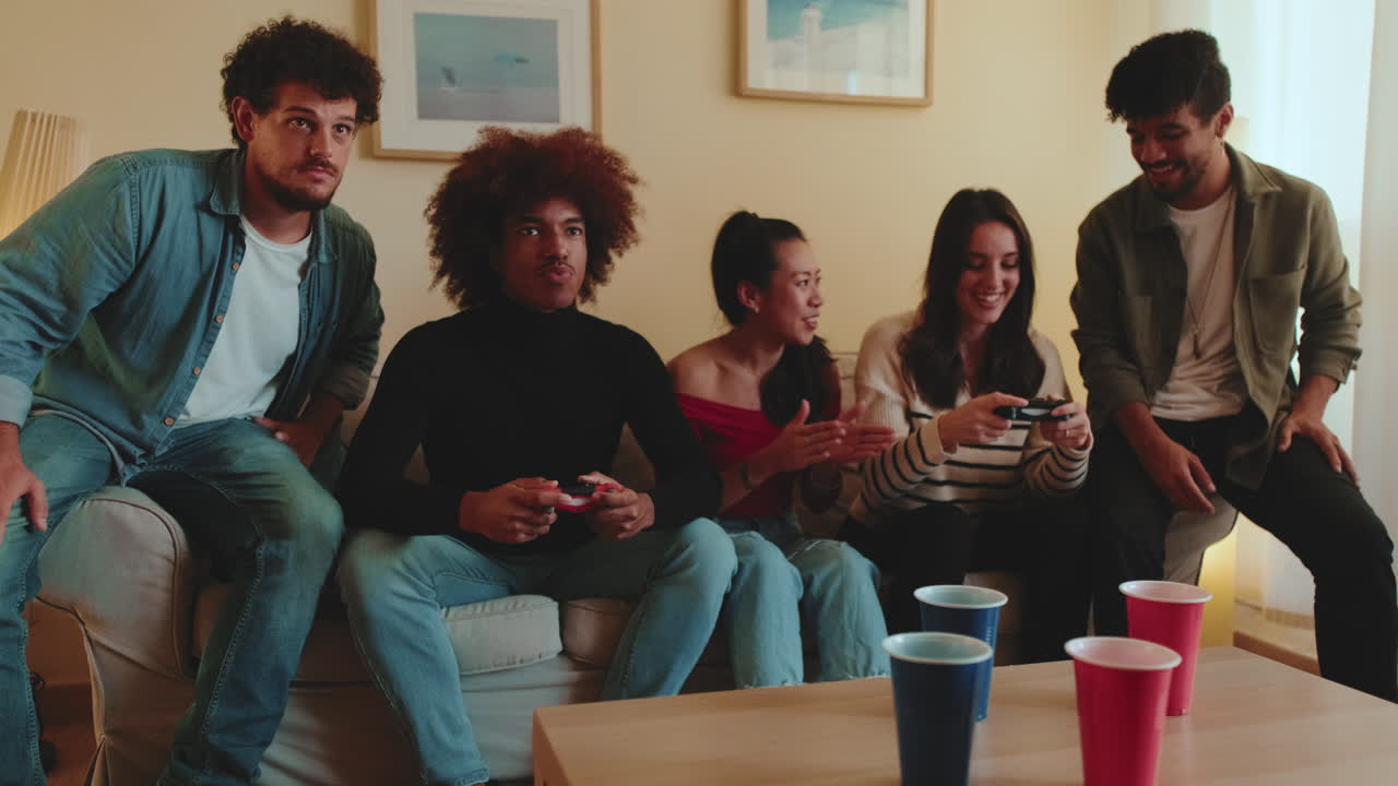 Friends having fun playing video games together