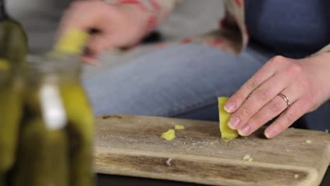 Woman-cooking-in-kitchen,-chop-boiled-potatoes-with-sharp-knife