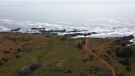 4K-30FPS-Aerial-Footage-Oregon-Coast---Epic-flying-drone-shot-of-pacific-ocean-shoreline,-waves-crashing,-and-hiking-trail-leading-out-to-the-PNW-coastline---Pacific-Northwest-Nature