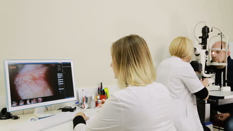 patient having eye examination. ophthalmologist measuring intraocular pressure of man in clinic