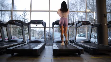 woman working out on treadmill in gym