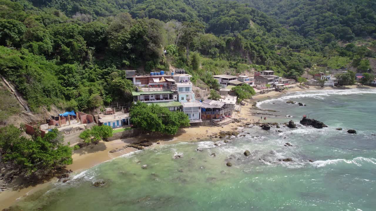 Coastal view of La Guaira with beachfront houses on three levels, overlooking the sea
