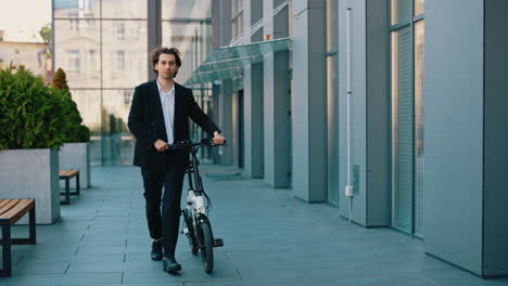 businessman walking an electric bicycle in the city