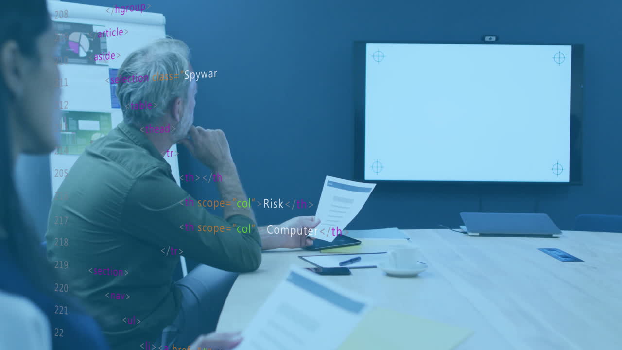 In office, team reviewing documents with animation of code overlay on screen