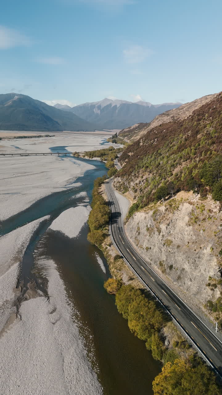 Aerial View of Winding Road Along a River Valley in New Zealand