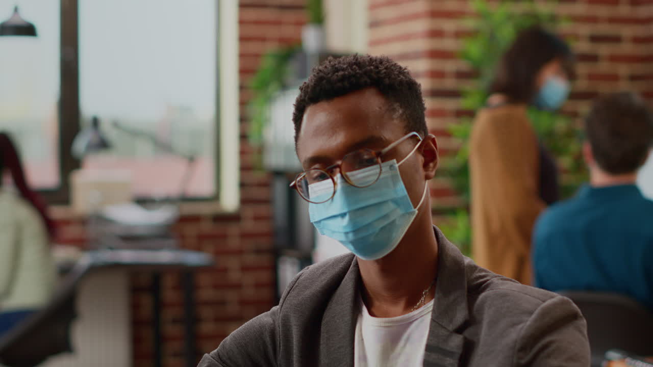 Business man with face mask working on startup project