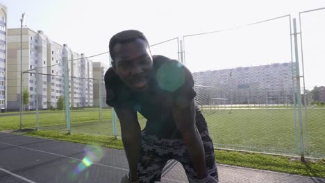 man resting after a run on a track