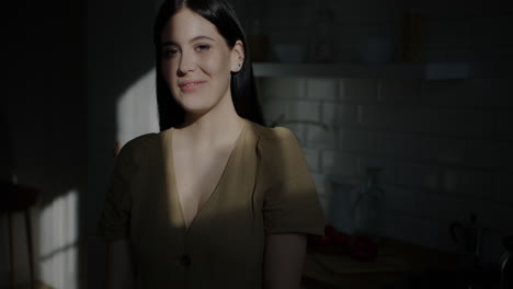 woman smiling in kitchen with sunlight