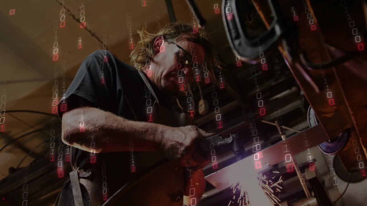 Workshop operator activating angle grinder and shaping metal bar, sparks lighting protective gear