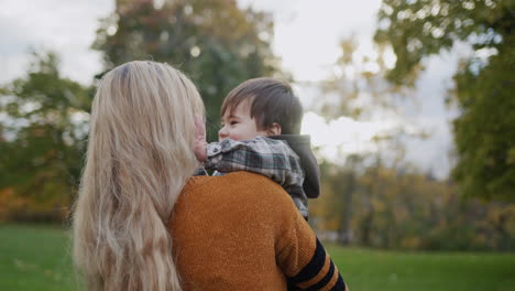 mom and son are walking in the autumn park