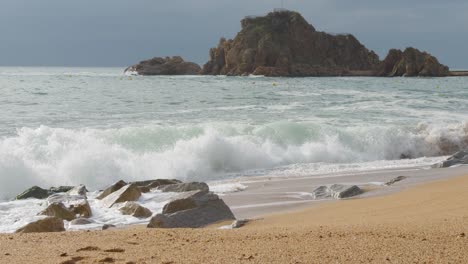 beach in costa brava , breaking waves in super slow motion