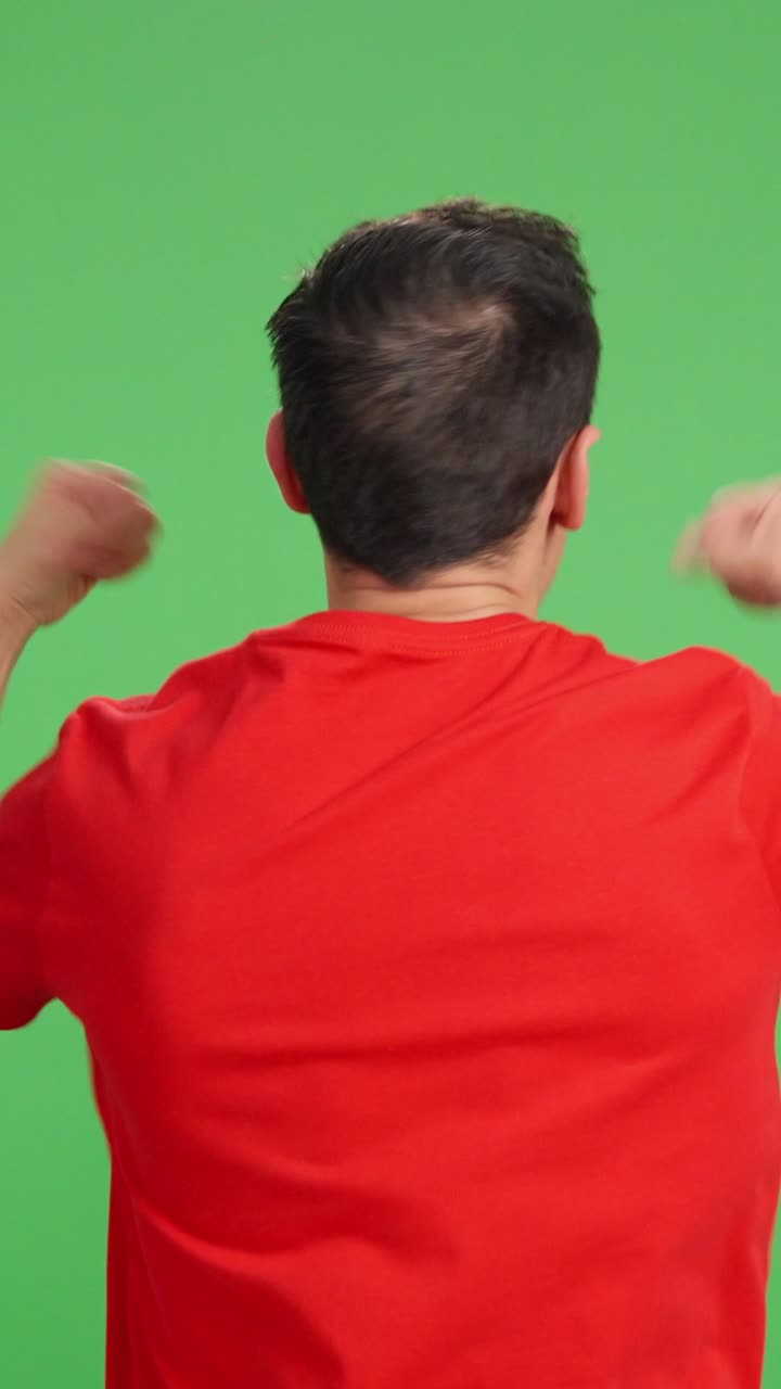 Man with his back turned celebrating and cheering