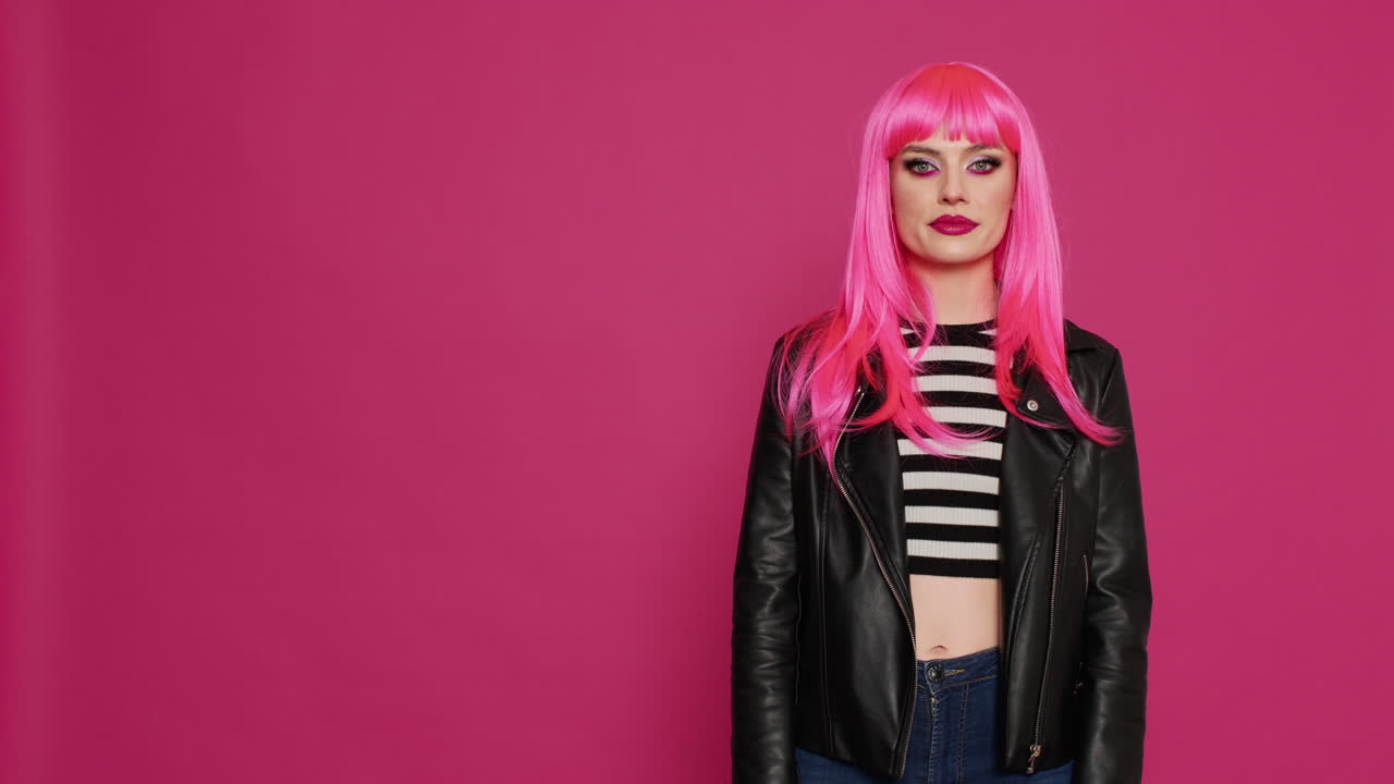 Attractive flirty woman showing heart shaped sign with hands