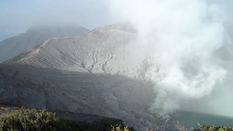 breathtaking view of a volcano crater with smoke