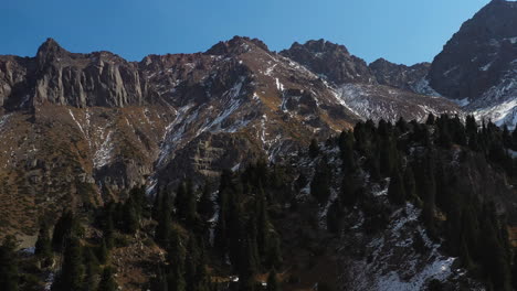 cinematic descending drone shot of the trans-ili alatau mountains in kazakhstan