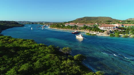 drone rises to sandals resort and barbara beach spanish waters, coast guard metal shark boat docked