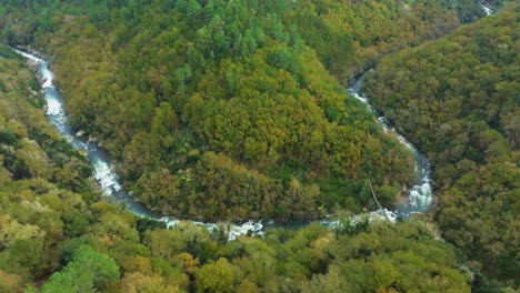 Drone-View-Of-A-River-In-Lush-Valley-At-Fervenza-do-Toxa-In-Pontevedra,-Galicia-Spain