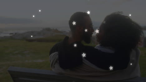 animation of stars over diverse couple embracing