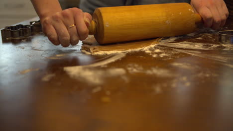 Flattening-dough-with-rolling-pin-and-adjusting-with-hand
