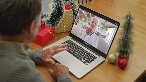 Caucasian-senior-man-on-video-call-with-senior-female-friend-at-christmas-time