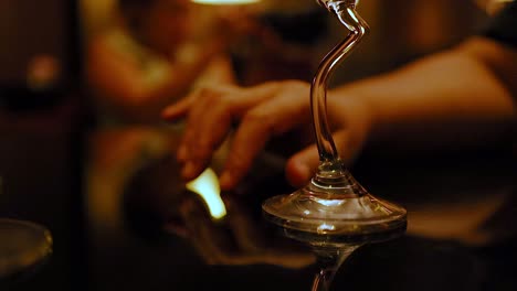 hand interacting with a reflective glass object