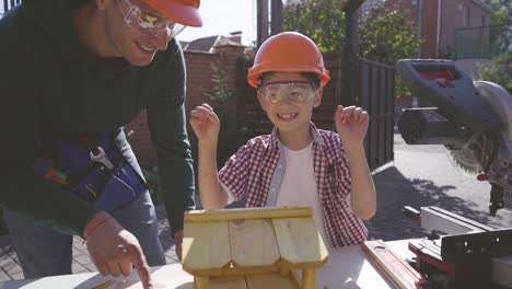 the father and son making carpentry together