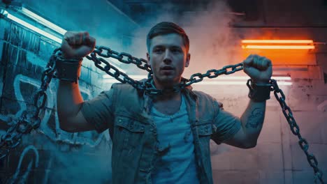 man struggling against chains in an urban neon setting