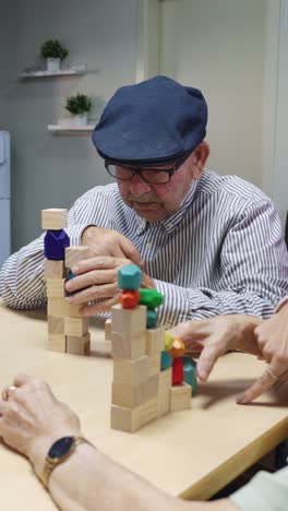 elderly person playing with wooden blocks in assisted living