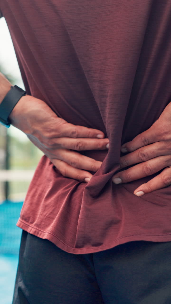 Person Holding Lower Back Due to Pain After Exercise