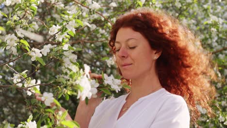 Woman smelling flowers in spring