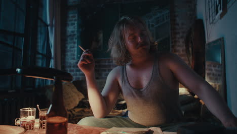 a man smoking in a dimly lit room