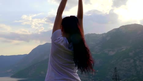 young woman enjoying the top of the mountain