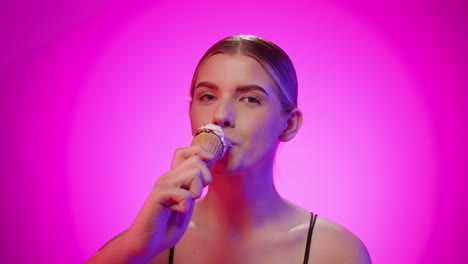 blonde white girl with big lips sucks an ice cream and tastes with tongue, studio shot with chroma background