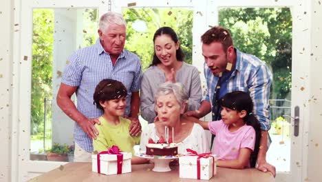 Animation-of-confetti-falling-over-family-having-fun-at-birthday-party