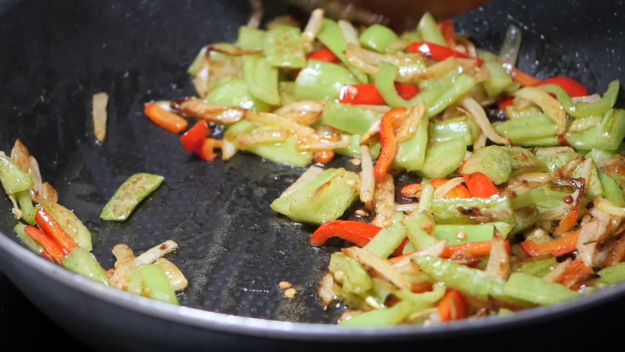 Stir-frying bell peppers and onions