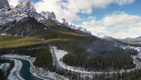 Aerial-pan-of-wildfire-smoke-plumes-with-mountains-and-Bow-River,-Alberta,-Canada