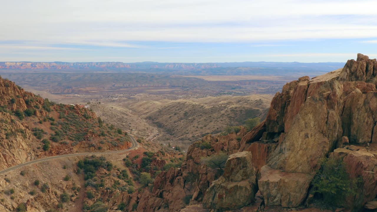 Gorgeous slow rising shot up a canyon wall to reveal massive canyon valley at sunrise. 4K footage