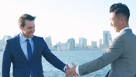 two businessmen in suits shaking hands