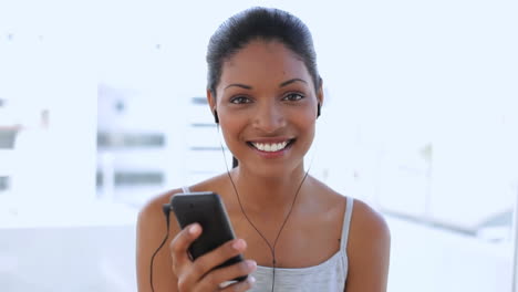 Smiling-woman-dancing-and-listening-music