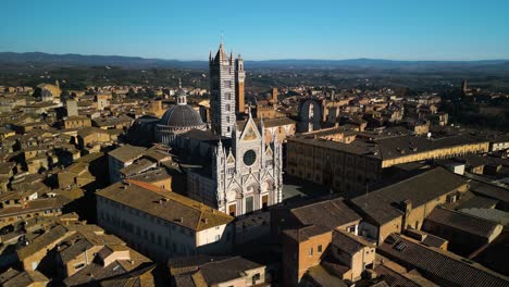 Drone-Orbits-Above-Siena-Cathedral-on-Beautiful-Day-in-Tuscany,-Italy