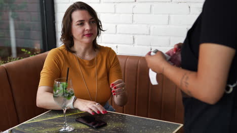 waitress giving bill to client