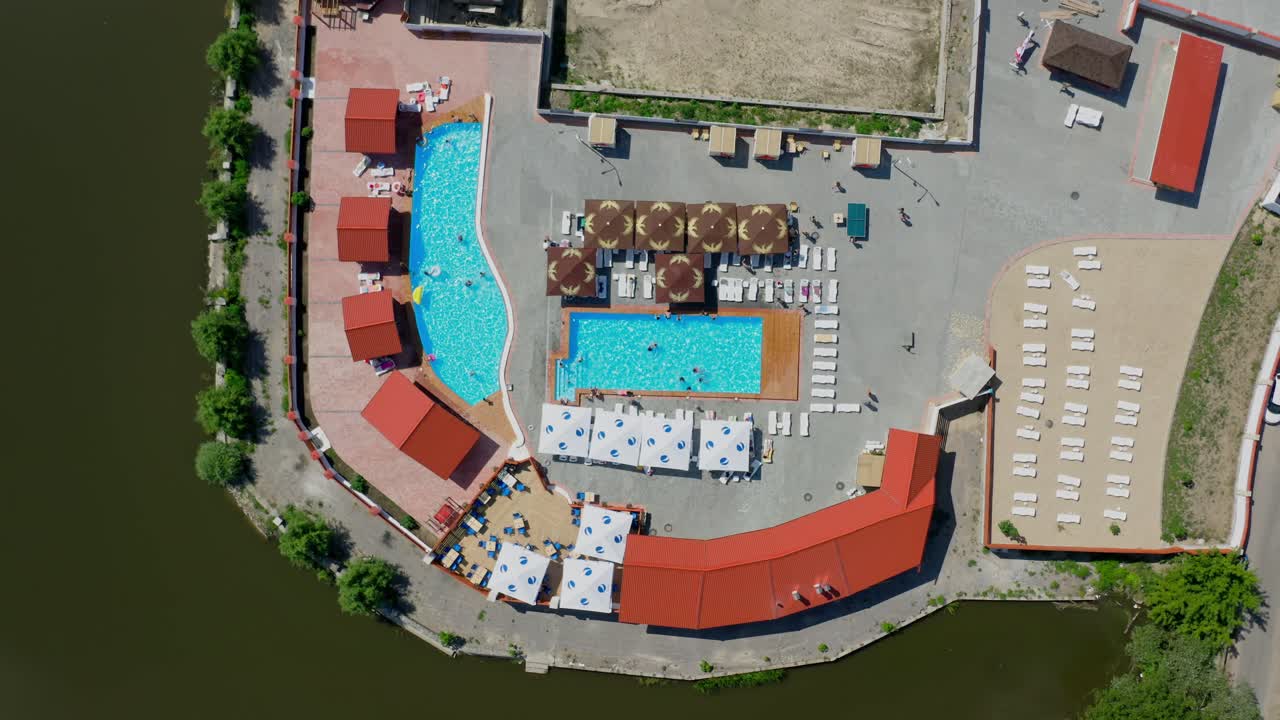 Vacation in pool resort. Aerial top view of public swimming resort pool
