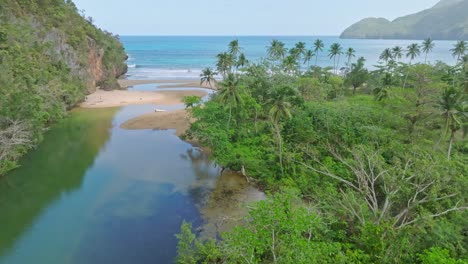 aerial forward flight over river río san juan and playa el valle during sunny day - tropical landscape in paradise