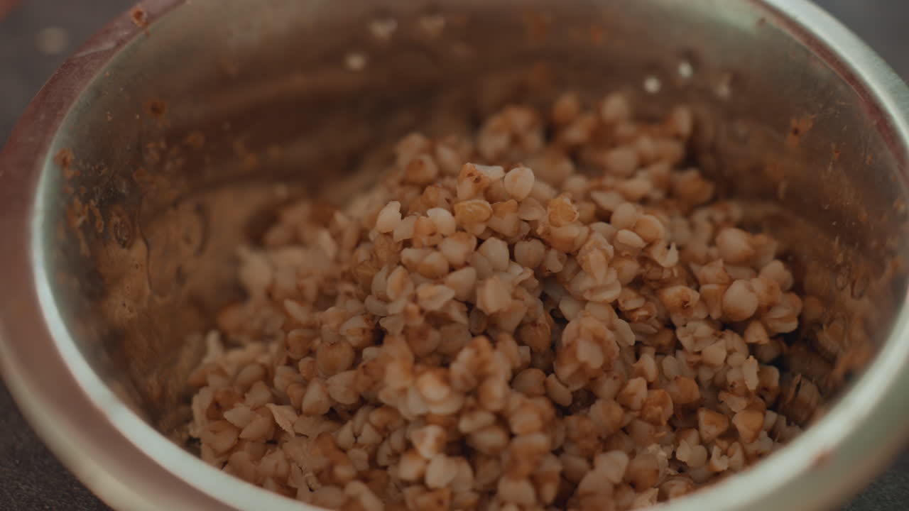 Closeup Buckwheat Porridge In Metal Bowl, Rustic Homemade Breakfast Scene, Steaming Brown Groats With Textured Grains, Warm Comfort Food, Simple Healthy Meal Prepared In Kitchen, Organic Wholesome
