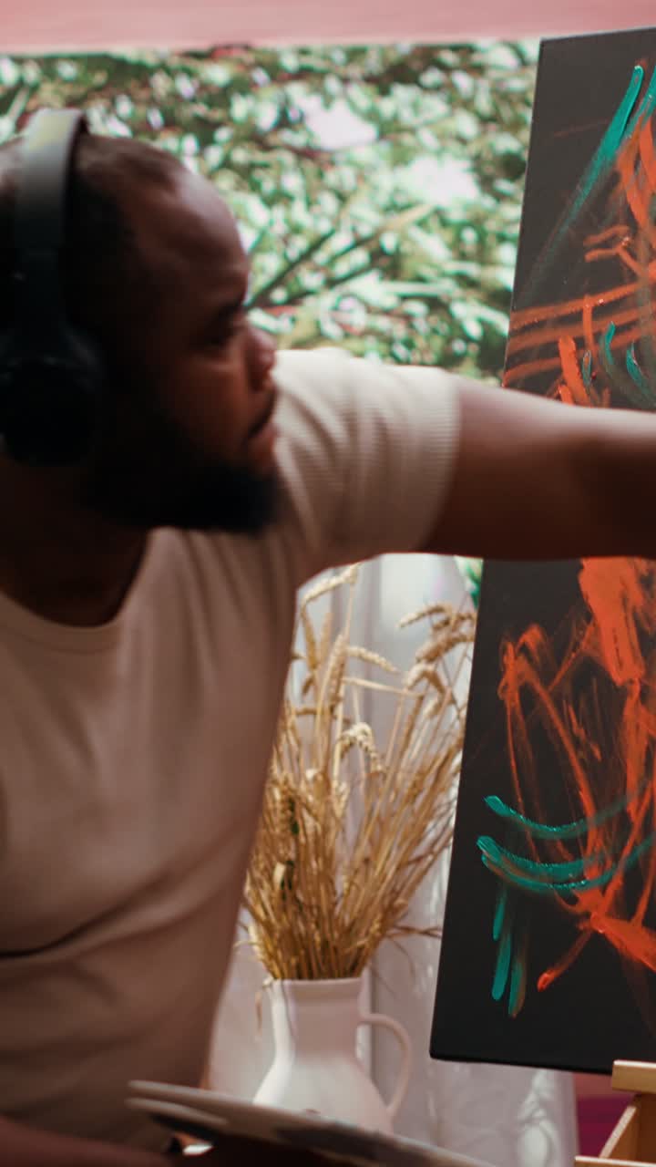 African American Man Painting Abstract Art with Fingers on Canvas