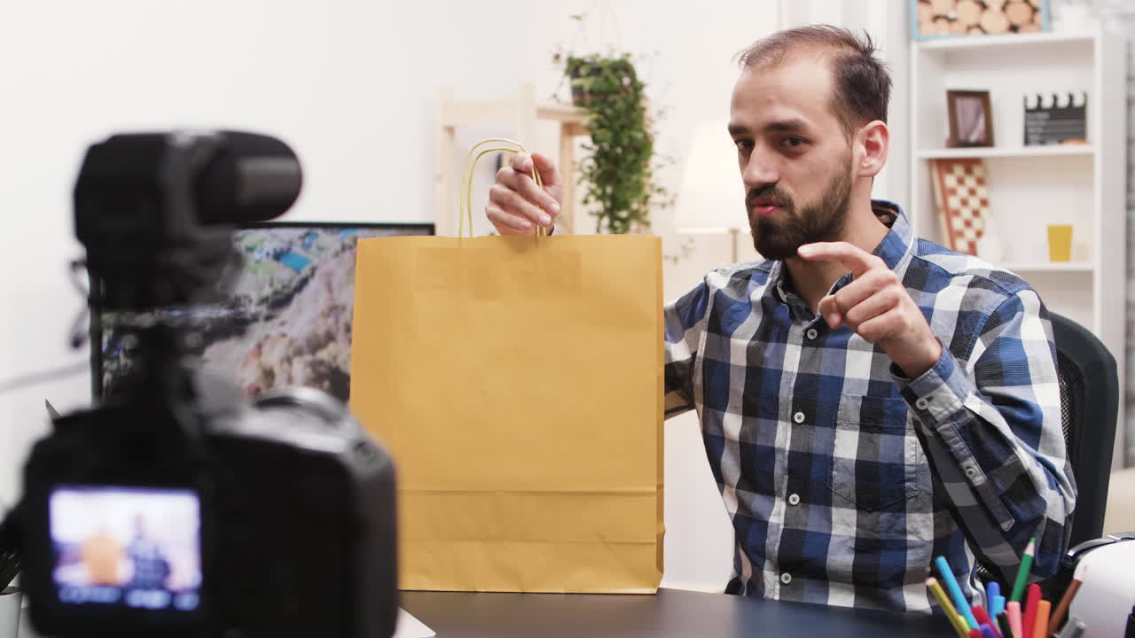 Man recording vlog with shopping bag