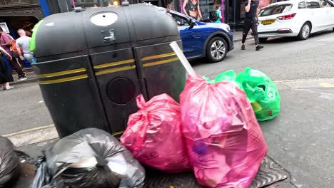 trash bags and pedestrians on a london street