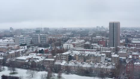 aerial drone shot over snow covered london park east bethnal green whitechapel