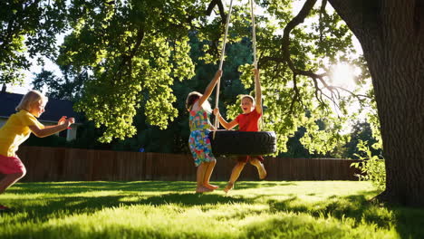 children playing on a tire swing in the backyard