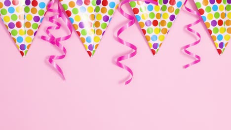party decorations with flag banners and ribbons on pastel pink theme. stop motion